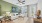 Jacksonville apartment living room featuring a sage green accent wall, chic furnishings, and access to an outdoor patio