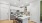 modern apartment kitchen with white cabinets, quartz countertops, and stainless steel appliances