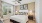 Bainbridge Avenues Walk apartment bedroom furnished with a bed, nightstands, and curtains