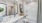 a spacious vanity, toilet, and oversized tub in a modern bathroom in a Bainbridge Avenues Walk apartment
